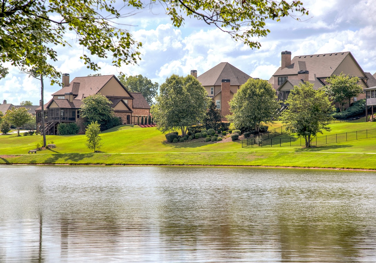 row of large houses overlooking a body of water
