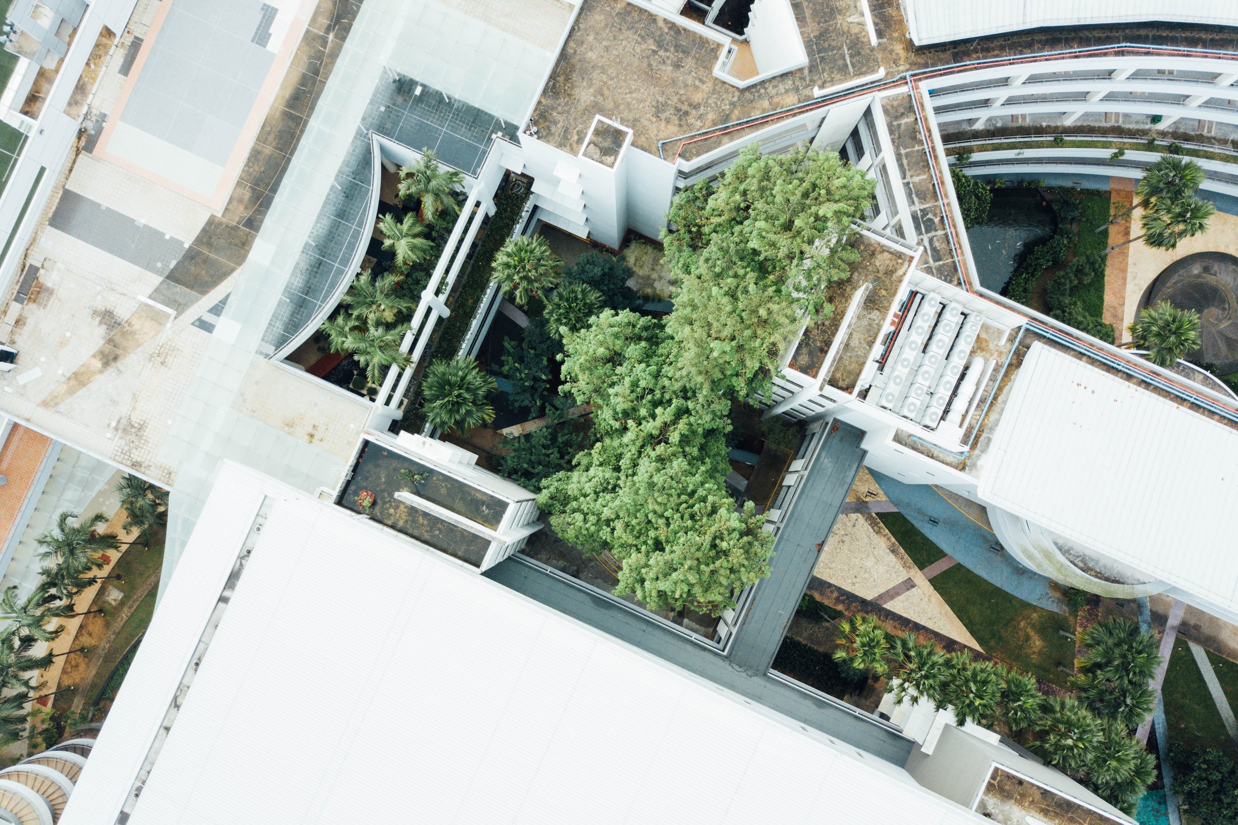 aerial view of commercial buildings with greenspace in the middle