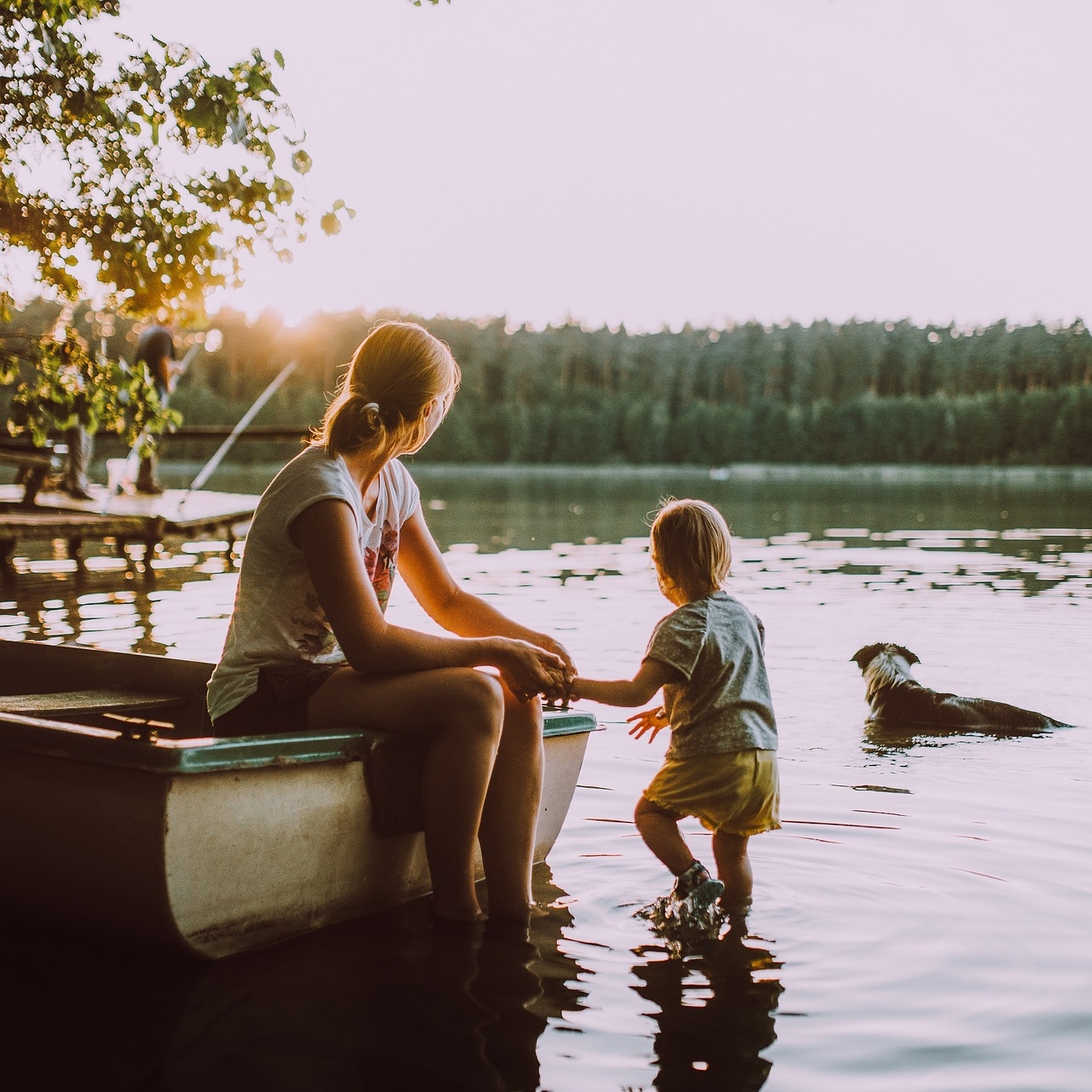 mother, son, and dog looking out at the water